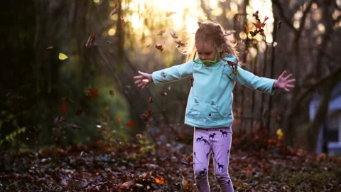 Child jumping in leaves Stock Footage 144910826