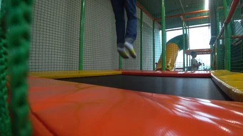 Child jumping on trampoline Stock Footage 97777601