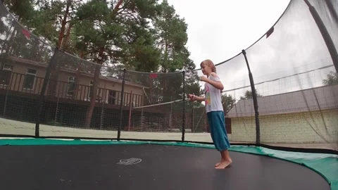 Child Jumping On A Trampoline Video stock 161080072