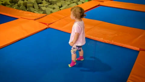 A child is jumping on a trampoline. Selective focus. Stock Footage 230248197