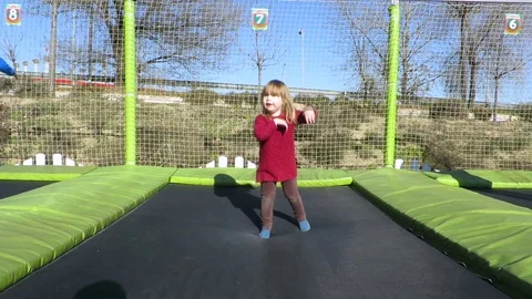Child jumping on trampoline slowmotion Stock Footage 71407952
