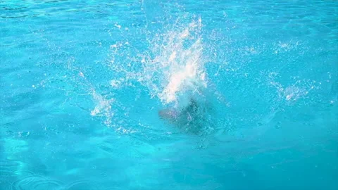 The child jumps dives into the pool. Selective focus. Stock Footage 166445706
