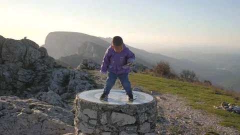 A child jumps for joy at the top of a mountain, in France Stock Footage 212505982