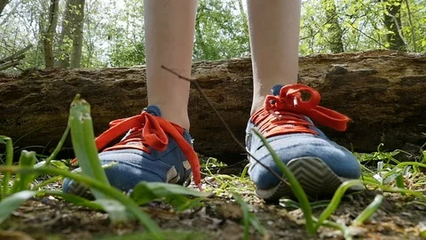 Child jumps off a log to land in front of camera in a forest in Slow Motion 库存影片 106989679
