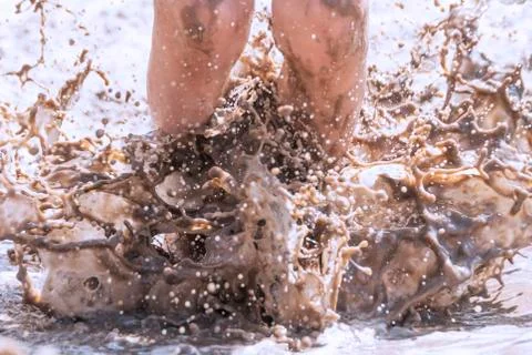 Child jumps in the mud Stock Photos