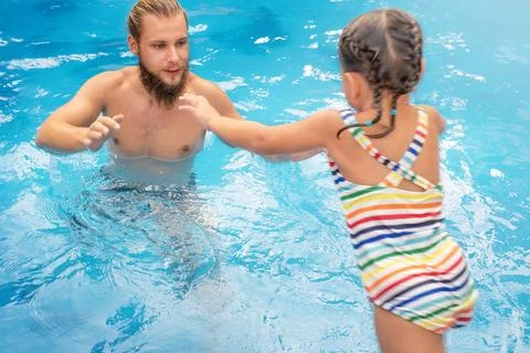 The child jumps into the pool Stock Photos
