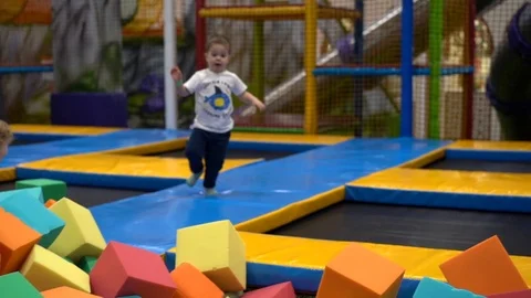 A child jumps on trampolines Stock Footage 127103155