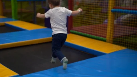 A child jumps on trampolines Stock Footage 127103286