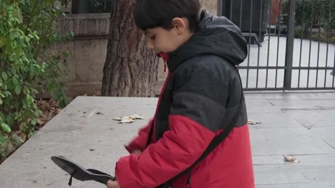 Child keeping camera in a bag Stock Footage 258374133