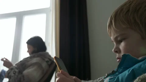 Child Kid Boy Use Watching Smartphone Internet Social Media. Mother Knit 4K Video stock 167815740