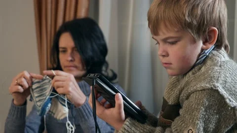 Child Kid Boy Use Watching Smartphone Internet Social Media. Mother Knit 4K Video stock 167818261