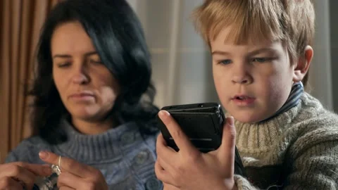 Child Kid Boy Use Watching Smartphone Internet Social Media. Mother Knit 4K Video stock 167818954