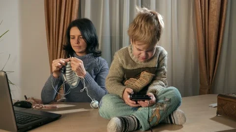 Child Kid Boy Use Watching Smartphone Internet Social Media. Mother Knit 4K Video stock 167819071