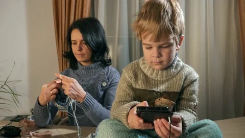Child Kid Boy Use Watching Smartphone Internet Social Media. Mother Knit 4K Video stock 167819189