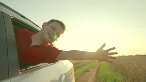 Child kid extends hand from car window, kid stuck head out window wind mixed Stock Footage 280945575