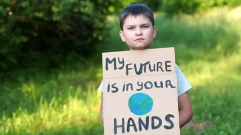 Child kid looking to camera with My Future in Your Hands poster support save  Stock Footage 134966534
