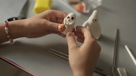 Child kid making Halloween ghost with pumpkin using clay. Halloween handmade Stock Footage 252216066