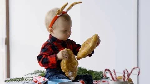 Child in the kitchen eating croissant Stock Footage 85035384