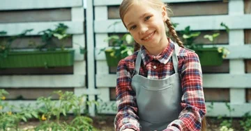 Child in the kitchen garden smiling at camera Stock Footage 85531853