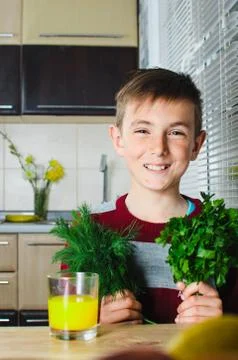 The child in the kitchen with herbs Stock Photos
