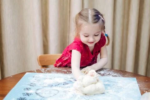 A child kneads the dough Stock Photos