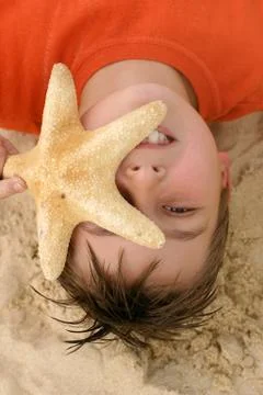 Child with a large starfish Stock Photos