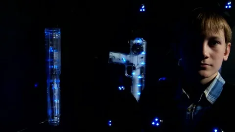 Child with a laser tag weapon takes aim at the camera Stock Footage 77356236
