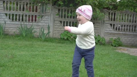 A child is laughing in the yard Video stock 295378544