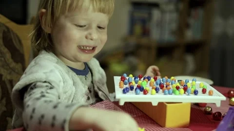 Child laughs while playing board children's games. Stock Footage 230291461