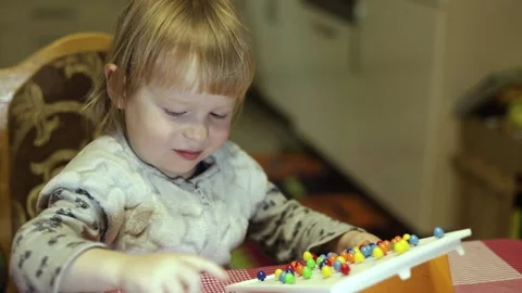 Child laughs while playing board children's games. Stock Footage 230292120