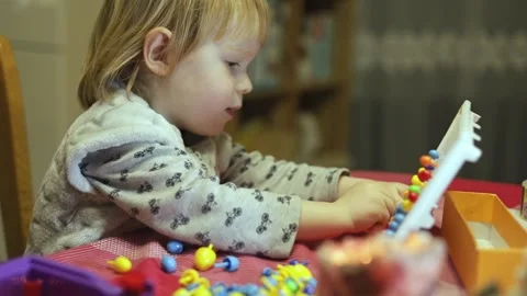 Child laughs while playing board children's games. Stock Footage 230292467