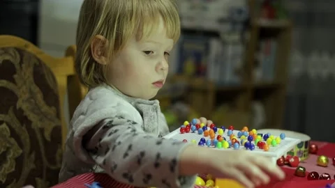 Child laughs while playing board children's games. Stock Footage 230292469