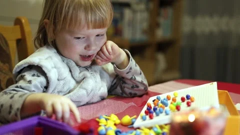 Child laughs while playing board children's games. Stock Footage 230292560