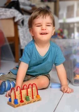 Child laughs while playing educational counting game Stock Photos