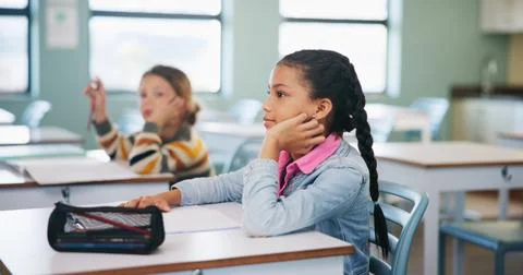 Child, learning and lesson in classroom, knowledge and listening to teacher for Stock Photos