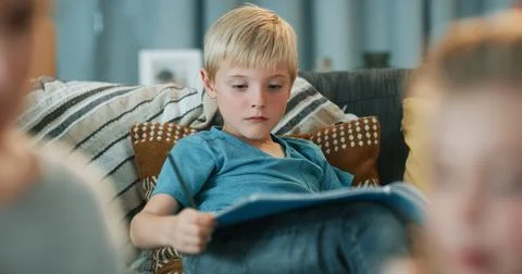 Child, learning and reading book in living room with knowledge, literature .. Stock Photos
