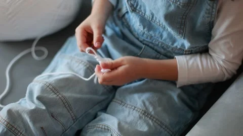 Child, learning crocheting, knitting, hand Crochet basics. Kid sitting at h.. Video stock 302347329