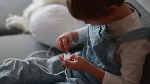 Child, learning crocheting, knitting, hand Crochet basics. Kid sitting at h.. Video stock 302347594