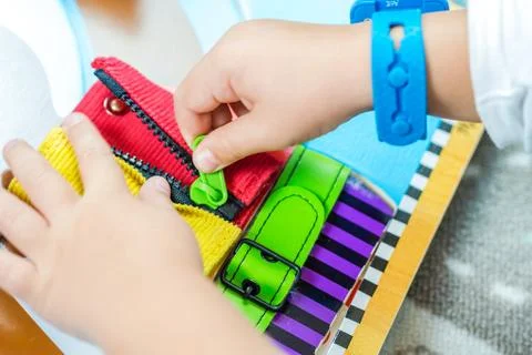 Child is learning to do up zip Stock Photos