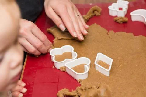 Child learning how to make cookies at home. Stock Photos