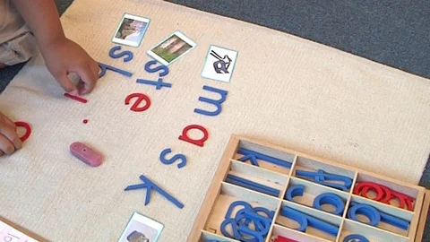 A child learning how to spell  in a Montessori School Class  Stock Footage 83224845