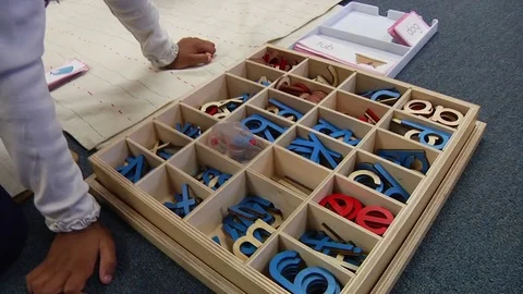 A child learning how to spell  in a Montessori School Class  Video stock 83225189