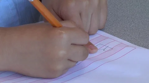 A child learning how to write in a Montessori School Class  Stock Footage 83225550
