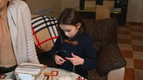 Child Learning to Knit at Home Stock Footage 297512244