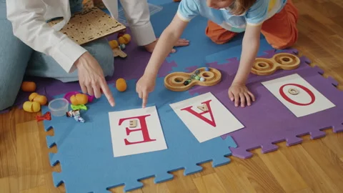 Child learning letters with therapist in educational play session. Early Stock Footage 272955736