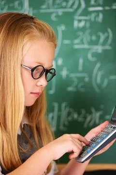 Child, learning math and board in classroom for problem solving, typing numbers 写真素材