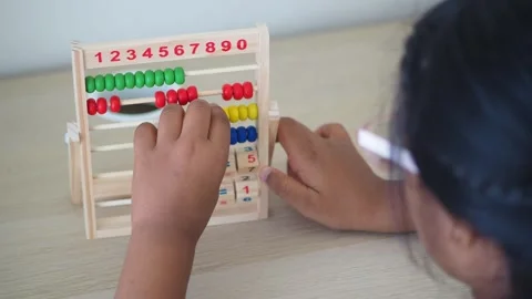 Child learning math with colorful abacus at home Stock Footage 321787027