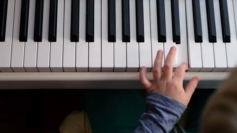 Child Learning to Play Piano on a Digital Keyboard Stock Footage 290105558
