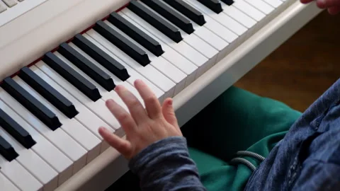 Child Learning to Play Piano on a Digital Keyboard Stock Footage 290105577