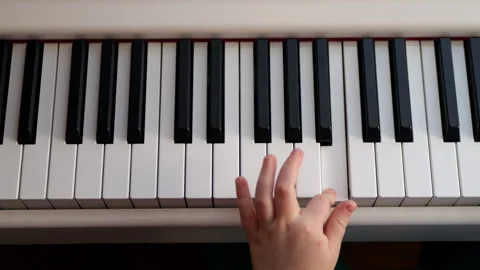 Child Learning to Play Piano on a Digital Keyboard Stock Footage 290105607